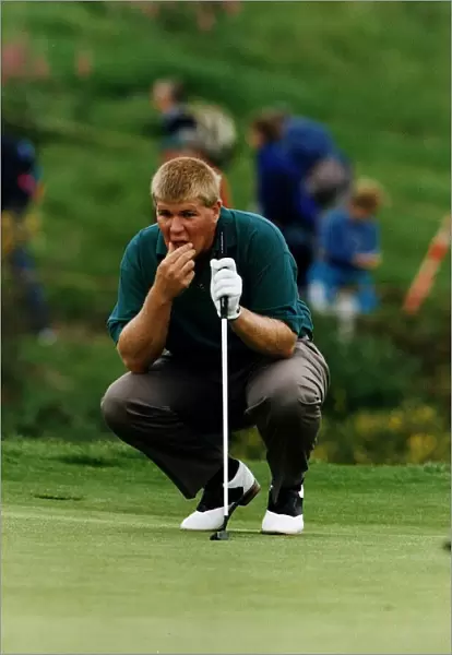 John Daly kneels to contemplate shot holding putter golf Scottish Open at Gleneagles