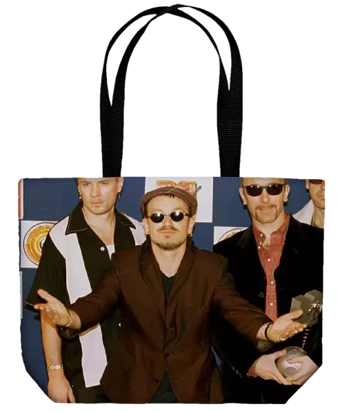 Bono, lead singer of Irish rock group U2, looks bemused after his band received the Best