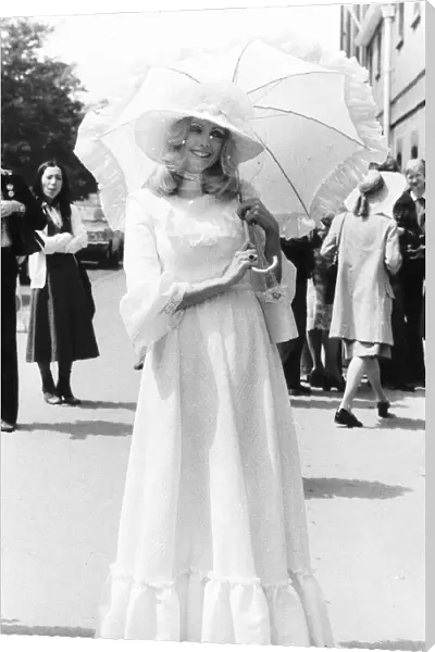 Fashionable racegoer with parasol at Royal Ascot in 1977 Seventies fashion