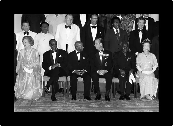 Prime Minister Margaret Thatcher seated with Queen Elizabeth IIand Prince Philip in