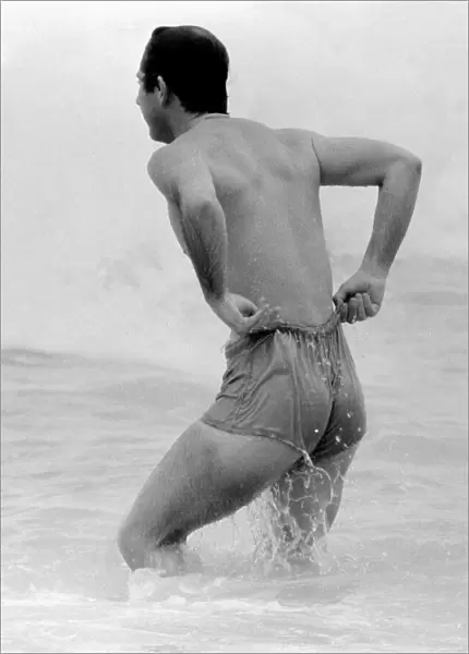 Prince Charles pulling up his shorts on a beach in Australia royal Prince of