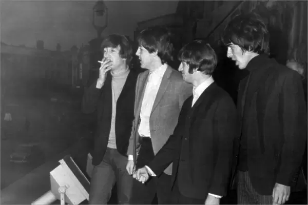 The Beatles enjoy a cigarette break on the balcony of the Empire Theatre in Liverpool 8th