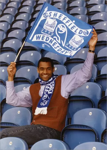 Mark Bright footballer for Sheffield Wednesday sits in seats and waves a flag