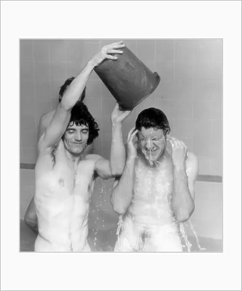 ace Kevin Keegan pours a bucket of water May 1977 over team mate Emlyn Hughes