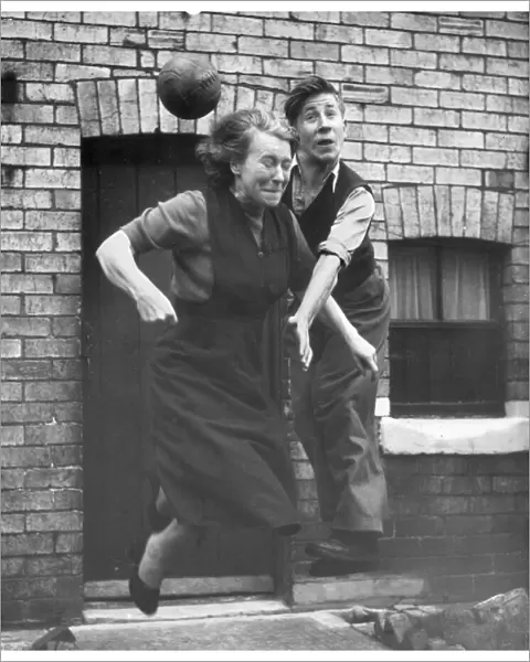 Manchester United starlet Bobby Charlton practices his heading skills with his mum