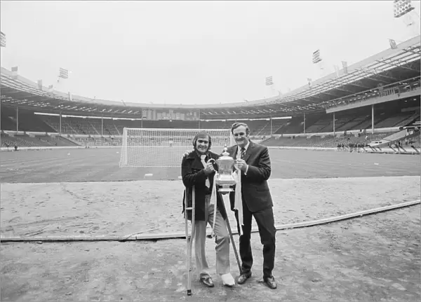Don Revie poses with Terry Cooper and the F. A. Cup following Leeds United victory over