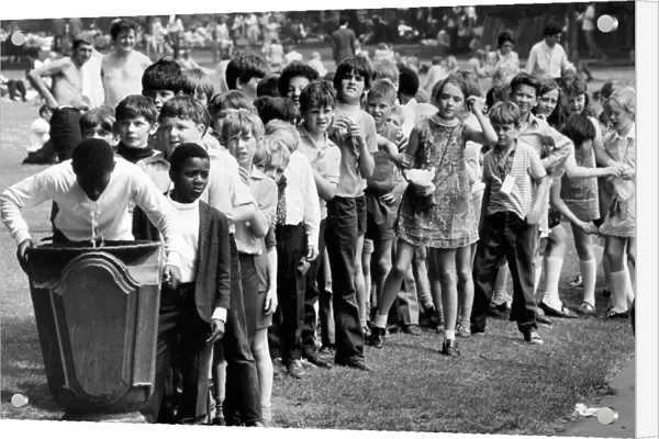 Children from St. Thomas Primary School queuing at a fountain. 9th July 1971