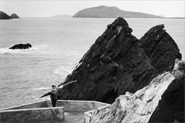 a fisherman makes his way down to the harbour on Ireland