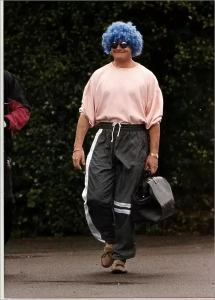 Glasgow Rangers footballer Paul Gascoigne wearing a curly blue wig and sunglasses