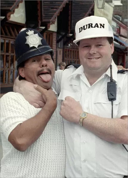 Middle Weight Boxer Roberto Duran seen here in the strong arm of the law as he hams it up