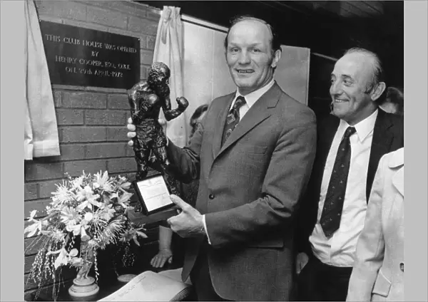 Former British Heavyweight champion boxer Henry Cooper holds a bronze statue of himself