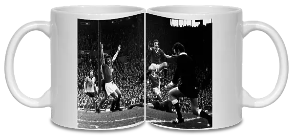 Manchester United footballers Lou Macari and Sammy McIlroy celebrates a goal by Gerry