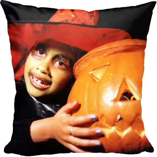 Halloween - Shiran Shah, six, dressed up as a witch with her pumpkin a St Monica