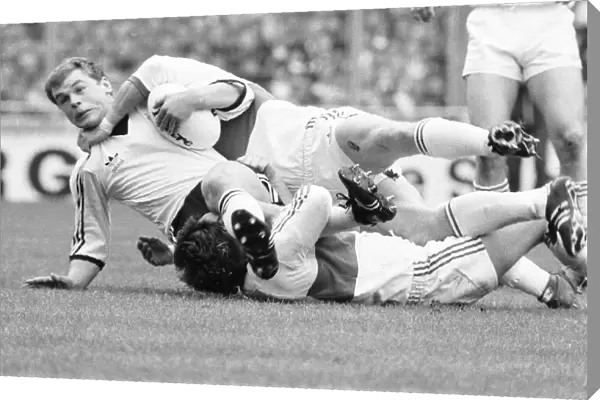 A Widnes player is brought down by a high tackle during the Rugby League Cup Final