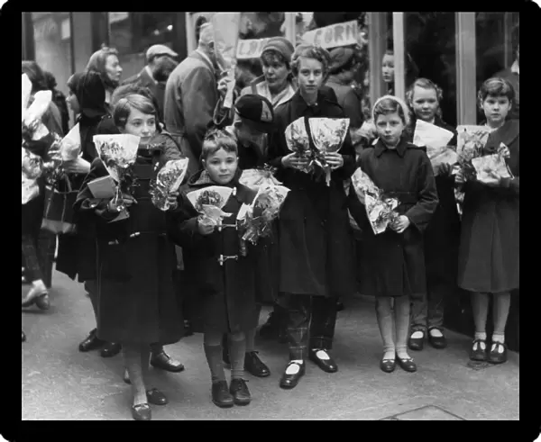 Children crowd outside a florists after buying thier flower for Mothering Sunday