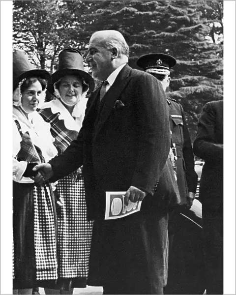 Home Secretary David Maxwell Fyfe greets a woman in national dress at the Welsh