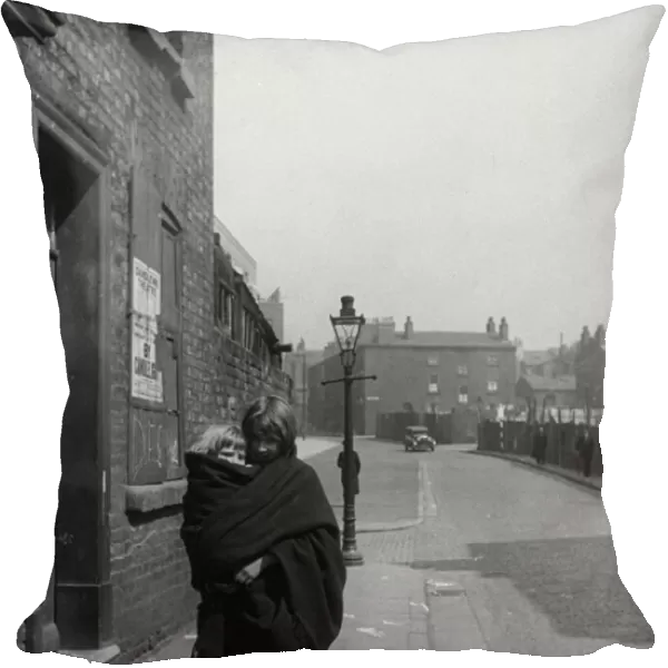 Young mother carries her child in a shawl, Liverpool. 3rd April 1939