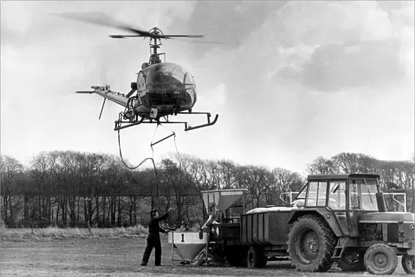 Pilot Tony Daly at the controls of his Hiller 12E helicopter spreading fertiliser at The