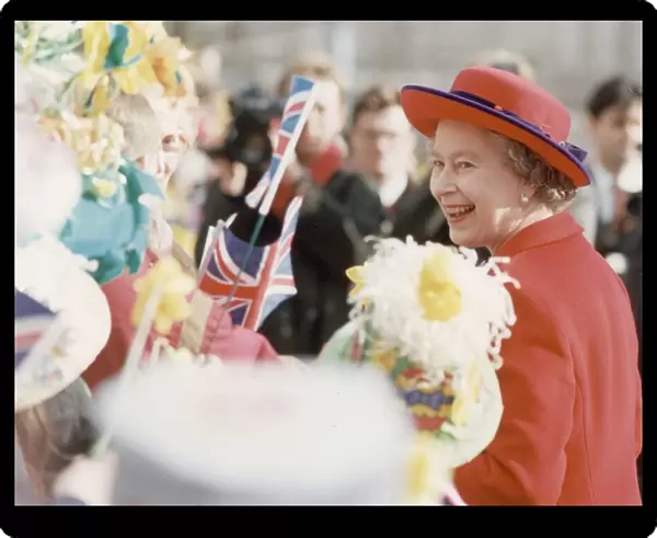 Queen Visits Manchester, the Queen receives flowers when she walks around on her visit to