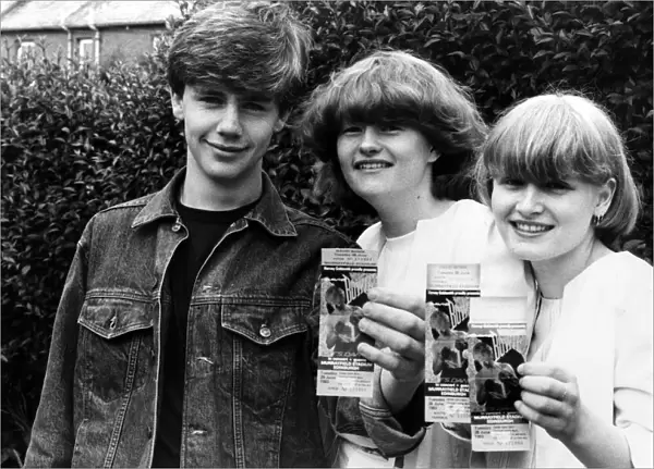 Fans of Singer David Bowie, proudly show off their tickets for his upcoming Murrayfield