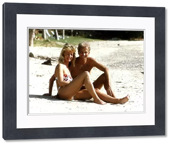 Cricketer David Gower cricketer with girlfriend Thorrun Nash on the beach during their
