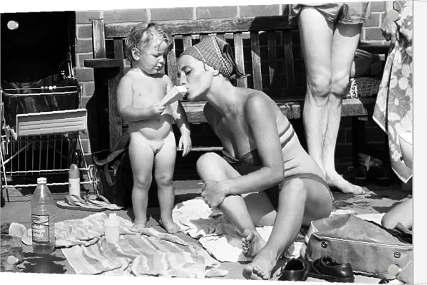 Mother and child try to keep cool at a Birmingham lido during the summer heatwave of 1976