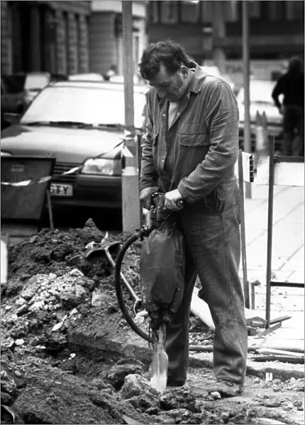 A workman on the 6th March 1989 using a pneumatic drill