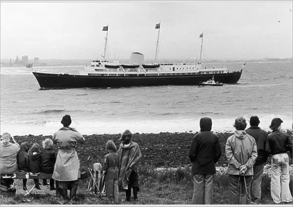 The first Teessiders to greet the Queen watch the Royal Yacht Britannia as she sails past