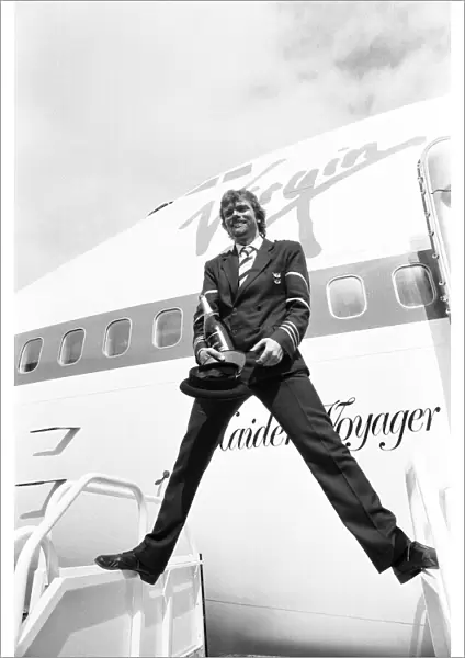 Richard Branson seen here dressed as a Virgin Atlantic pilots with a bottle of champagne
