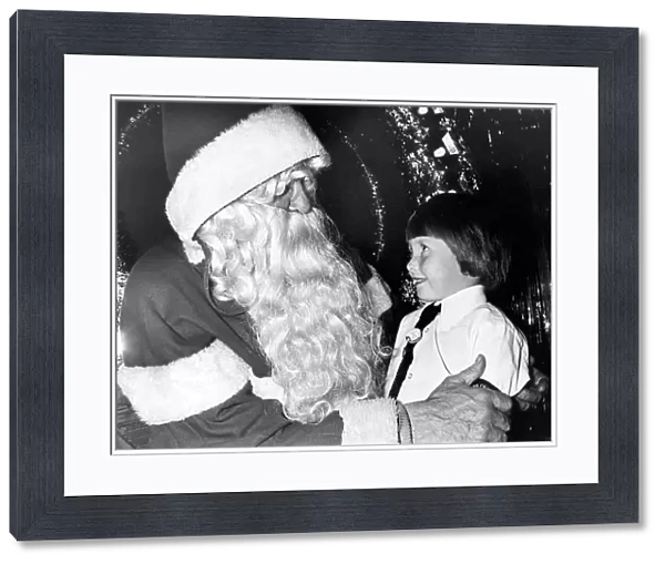 A young girl meeting Father Christmas in the grotto at Debenham s, Teesside