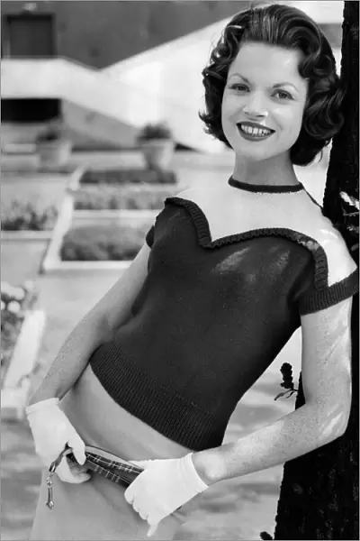 A woman modelling Knitwear. August 1956