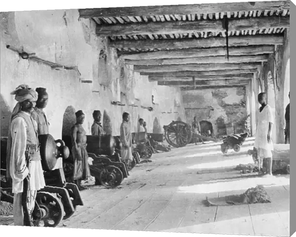 Arab soldiers seen here manning the gun battery at Fort Jelana at Muscat. Circa 1916