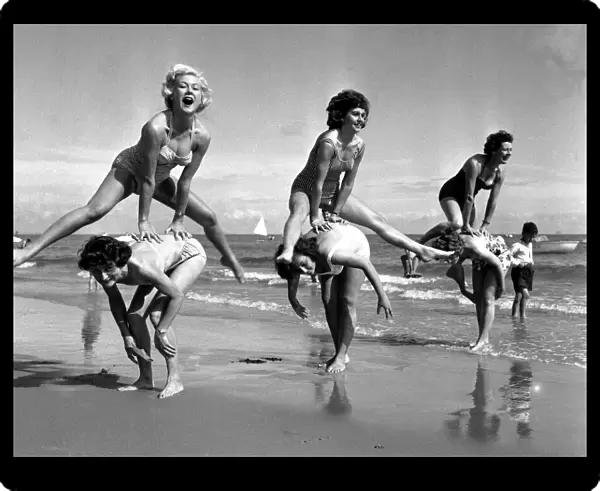 Beauty contest girls playing on the beach at Torquay, Devon. 7th September 1960