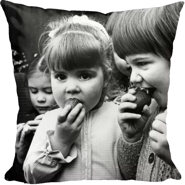 Children eating chocolate easter eggs, 27th March 1975