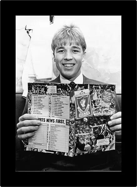 Swansea City footballer Andy Legg holding a football programme ahead of his side