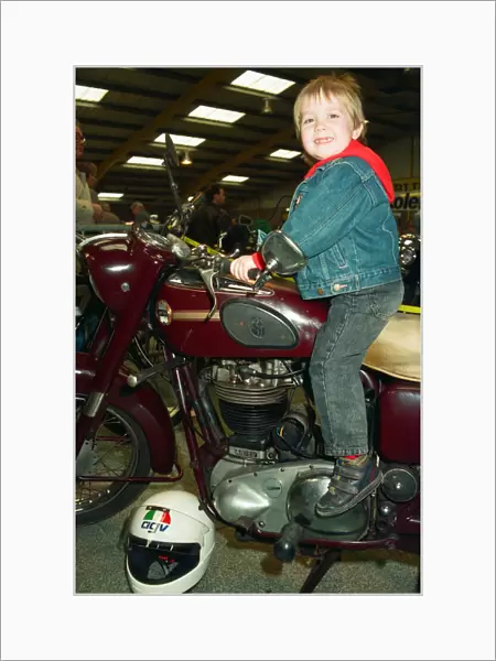Michael Tilley, aged three and a half, tries out a 1956 Ariel 500cc at the Classic Bike