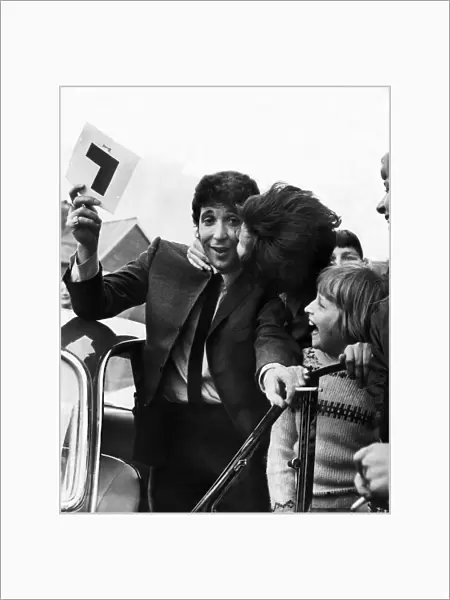 Tom Jones gets a kiss from a fan as he passes his Driving Learners test at Newport