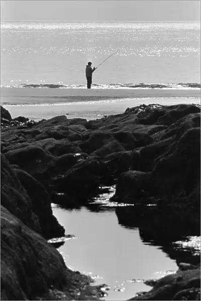 Ebbw Vale, Wales. Sea angler tries his luck off the mumbles of Ebbw Vale, 11th March 1971