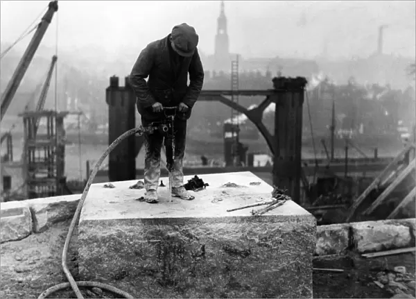 A workman drilling holes in one of the bedstones on the Gateshead abutment for