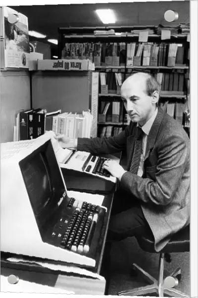 Deputy business and technical librarian Noel Hanson demonstrates the on-line computer