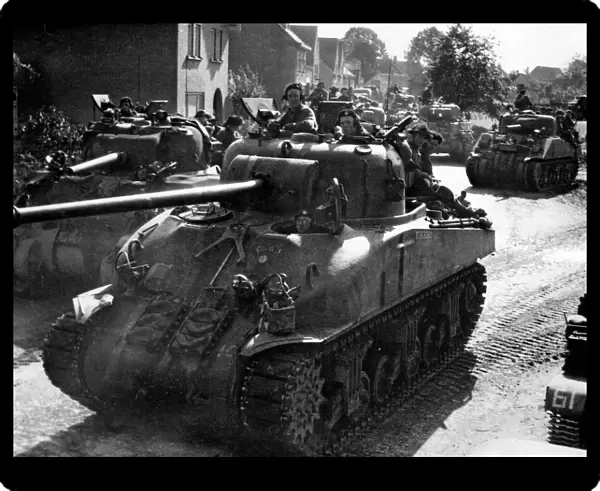 A Sherman Firefly 1C Tank of the 11th Armoured Division leads a column of tanks through