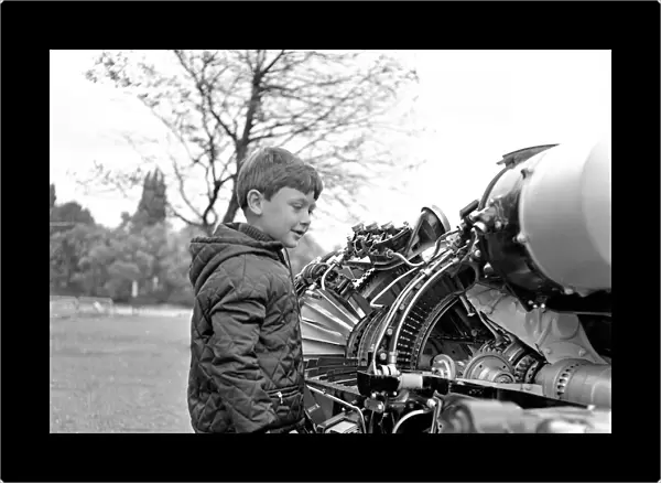 A young boy (unidentified) enjoys inspecting an engine at the RAF Display at Caversham