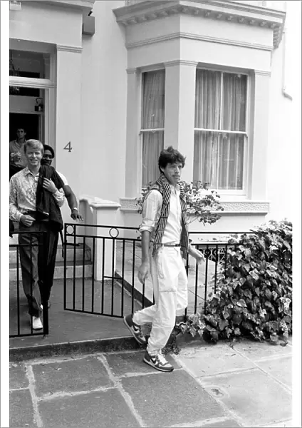David Bowie and Mick Jagger in London. Mick Jagger getting into the car