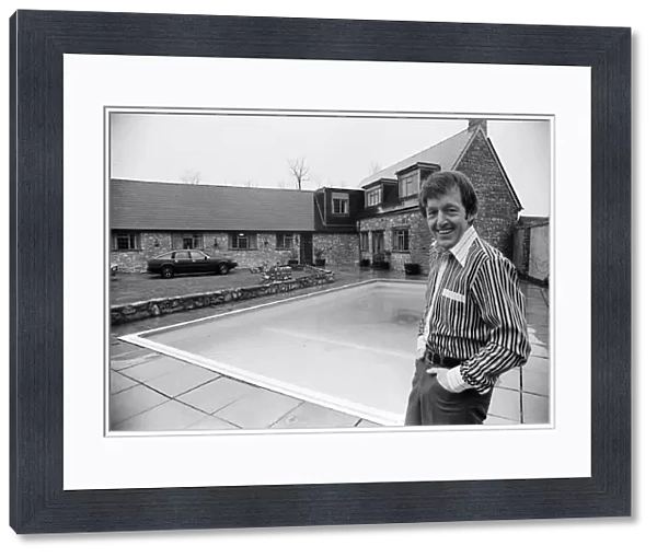 Magician Paul Daniels beside his swimming pool and house in Buckinghamshire