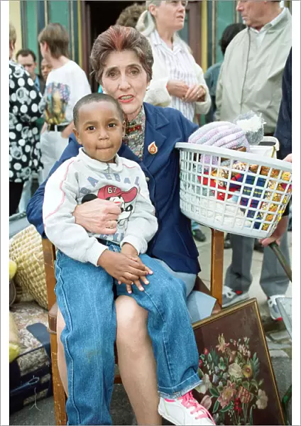 The cast of EastEnders on set. June Brown as Dot Cotton with a young cast member