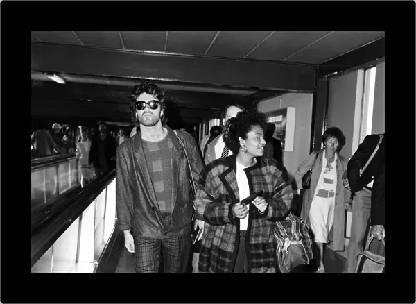 George Michael of the pop group Wham!, and girlfriend Pat Fernandez at London airport