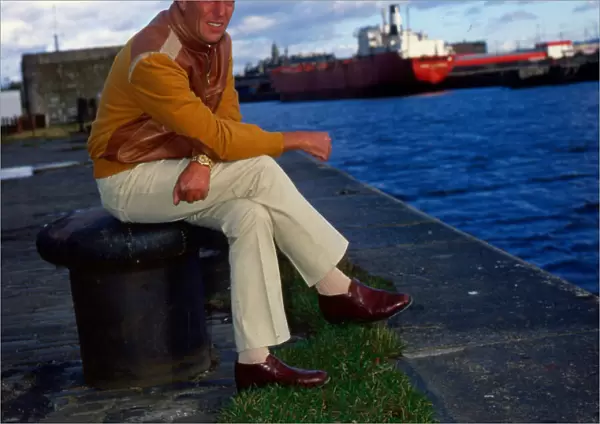 Frederick Forsyth sitting at docks September 1984