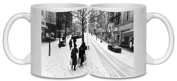 Huddled up against the winter snow, shoppers in a strangely quiet Church Street during
