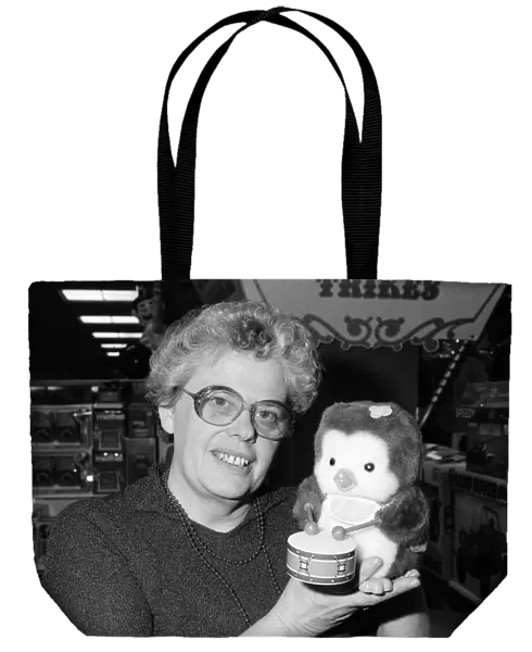 Mrs Beryl Bennington, Rackhams toy department manager, with a drumming penguin toy