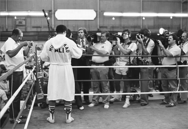 Muhammad Ali talks to reporters in his training camp ahead of his upcoming fight against
